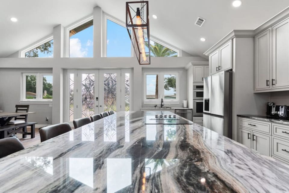 This stunning kitchen island features a luxurious marble countertop, providing ample space for cooking and socializing. The open design and natural light create a bright, inviting atmosphere.