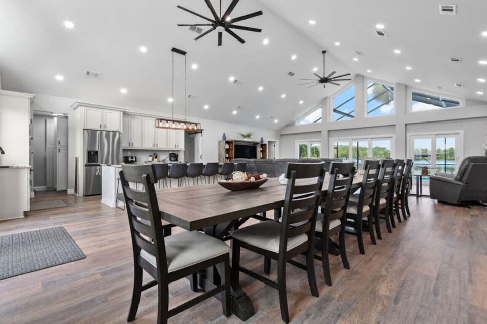 Gather around for meals or celebrations in this expansive dining area, perfect for large groups. The open-concept kitchen and living space create a warm and welcoming atmosphere with breathtaking lake views.