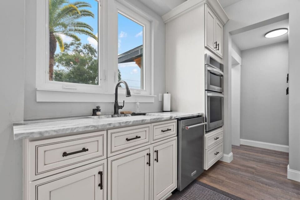 Wash up with a view! This bright and modern kitchen space features high-end finishes and beautiful natural light, making every task a little more enjoyable.