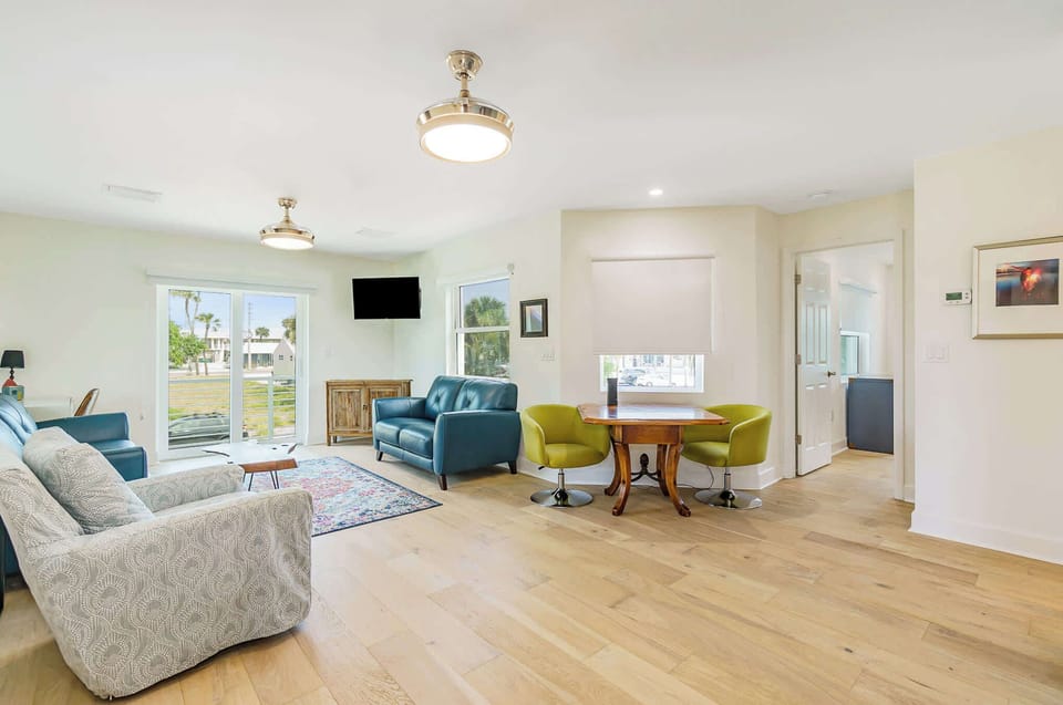 Bright living area with modern seating and natural light from large windows