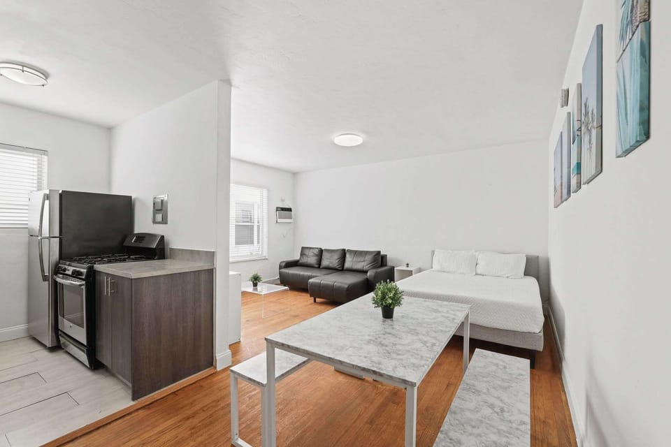 Bright and airy studio with modern amenities and cozy seating, perfect for a relaxing stay.