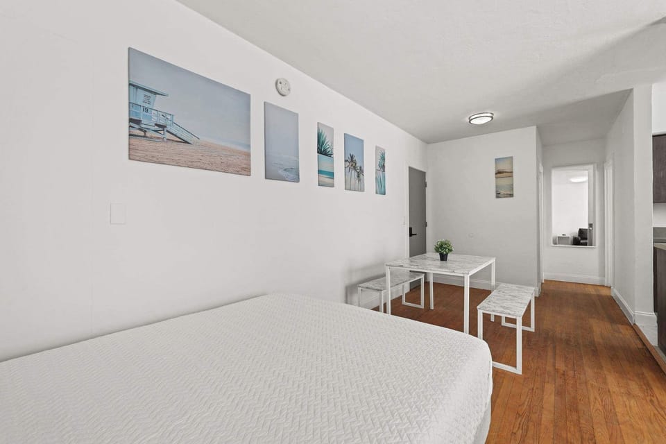 Cozy studio with beach-themed decor and a functional dining area, perfect for a relaxing stay.