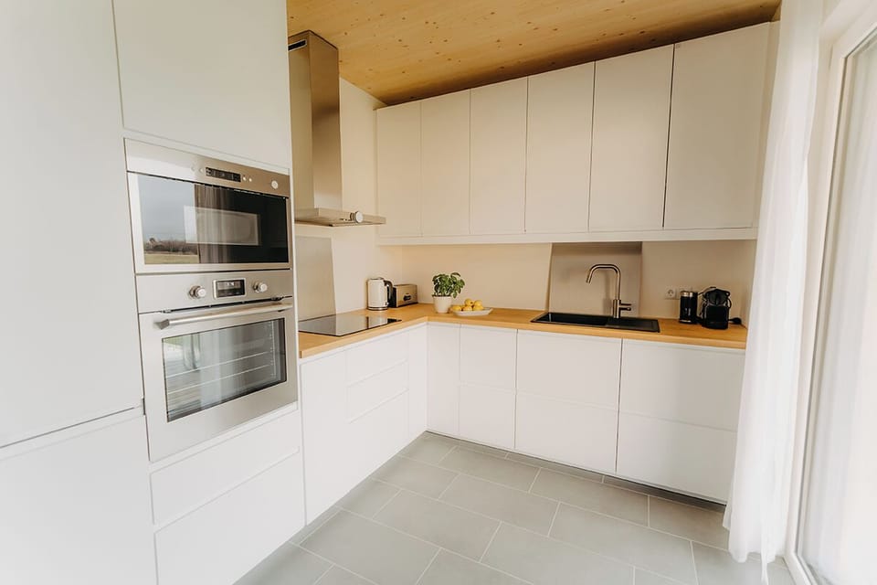 Deluxe Chalet, Garden View | Private kitchen | Electric kettle, highchair