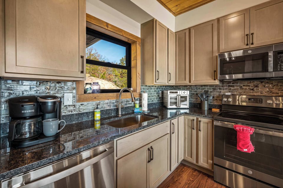 Featuring sleek stainless steel appliances and beautiful rich wood cabinetry, this space is perfect for cooking up your favorite meals and gather with friends and family.