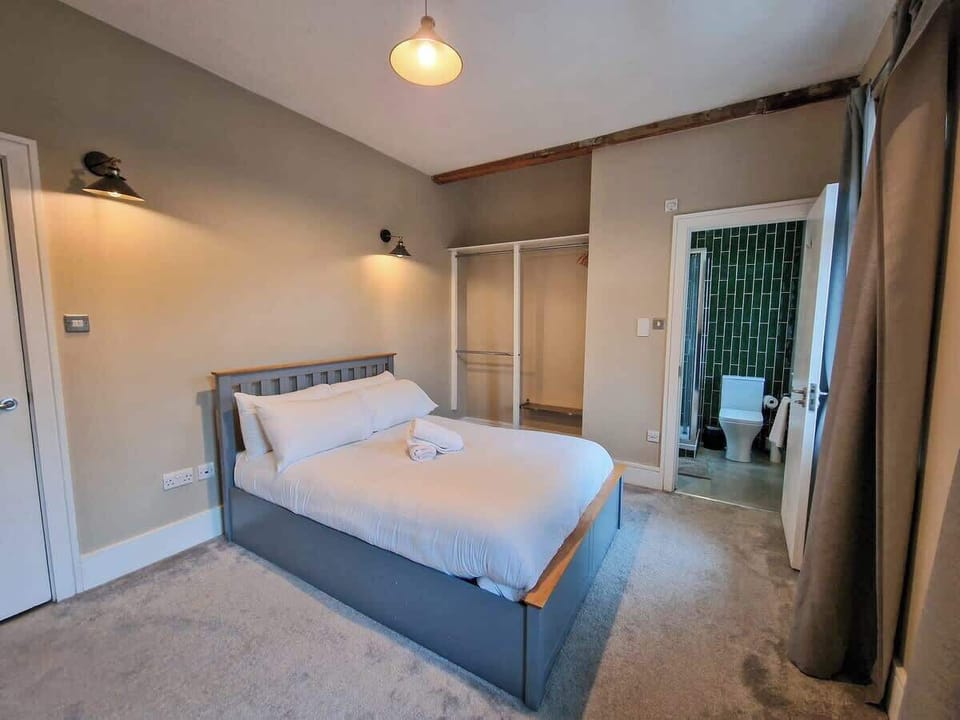 A bright, welcoming bedroom with crisp bedding and a calm atmosphere
