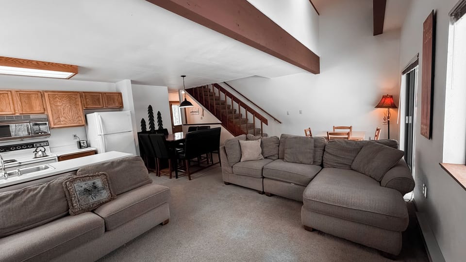Open concept living room with kitchen, living room, and dining area- perfect for groups
