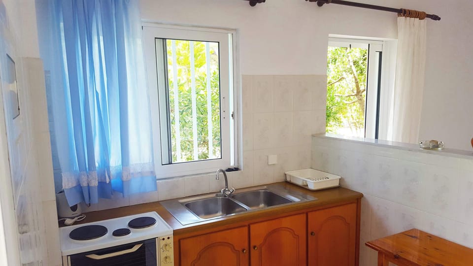 Basic Kitchenette Space with Dining Table – Naturally Lit and Functional

