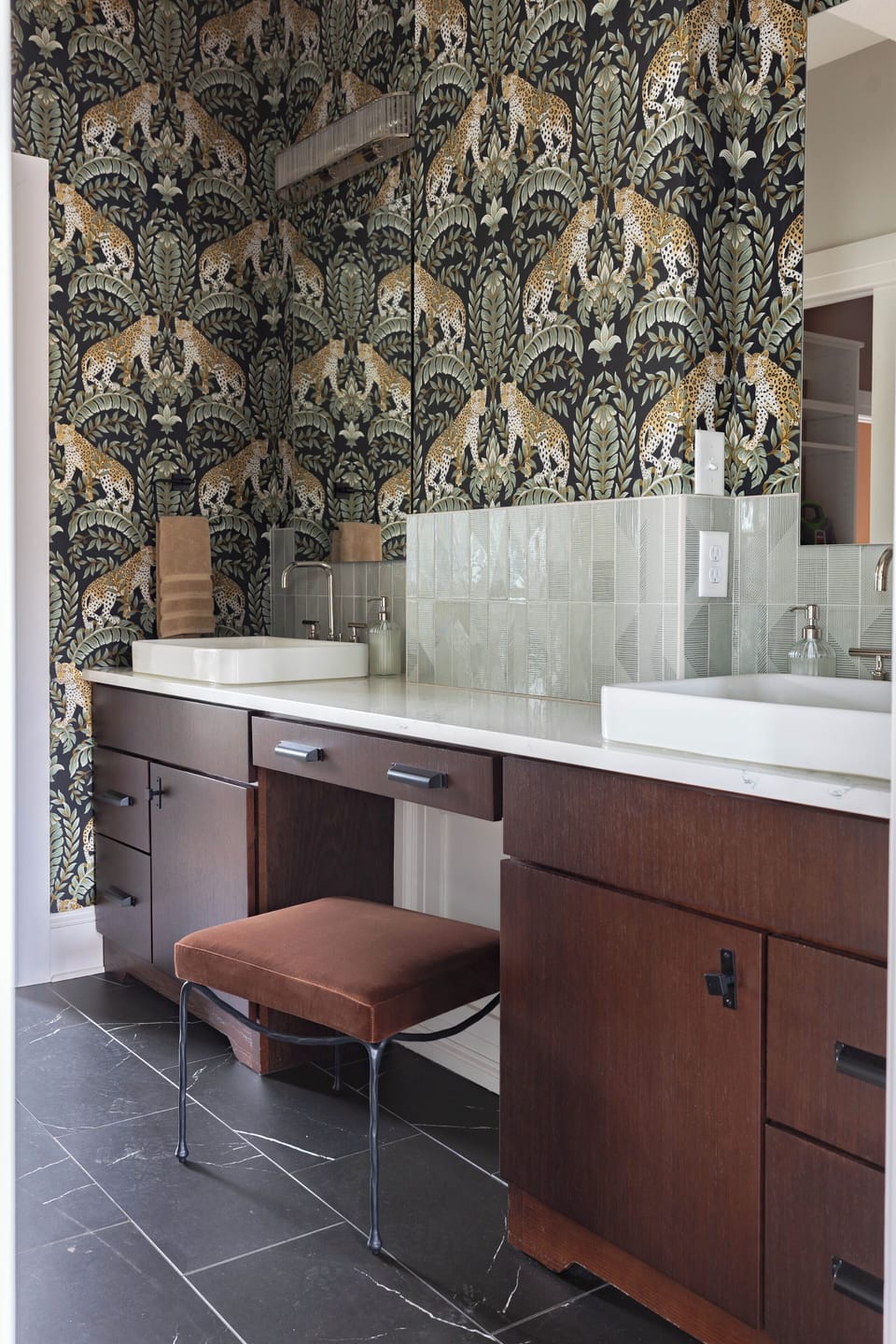 The master bathroom has dual sinks, as well as a vanity sitting area.