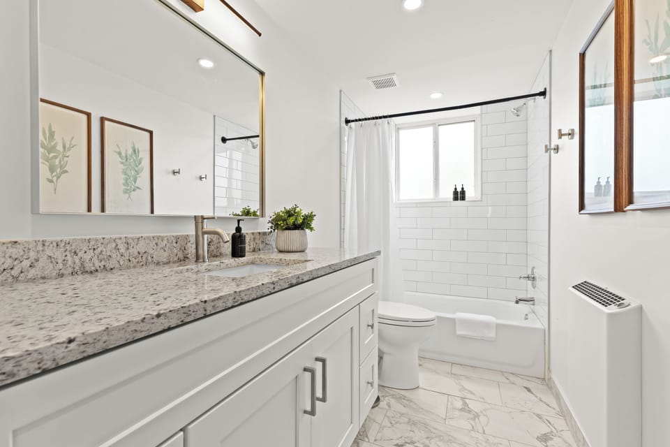 Bright, crisp, and fully stocked—this spa-inspired bathroom includes everything you need for a refreshing stay.