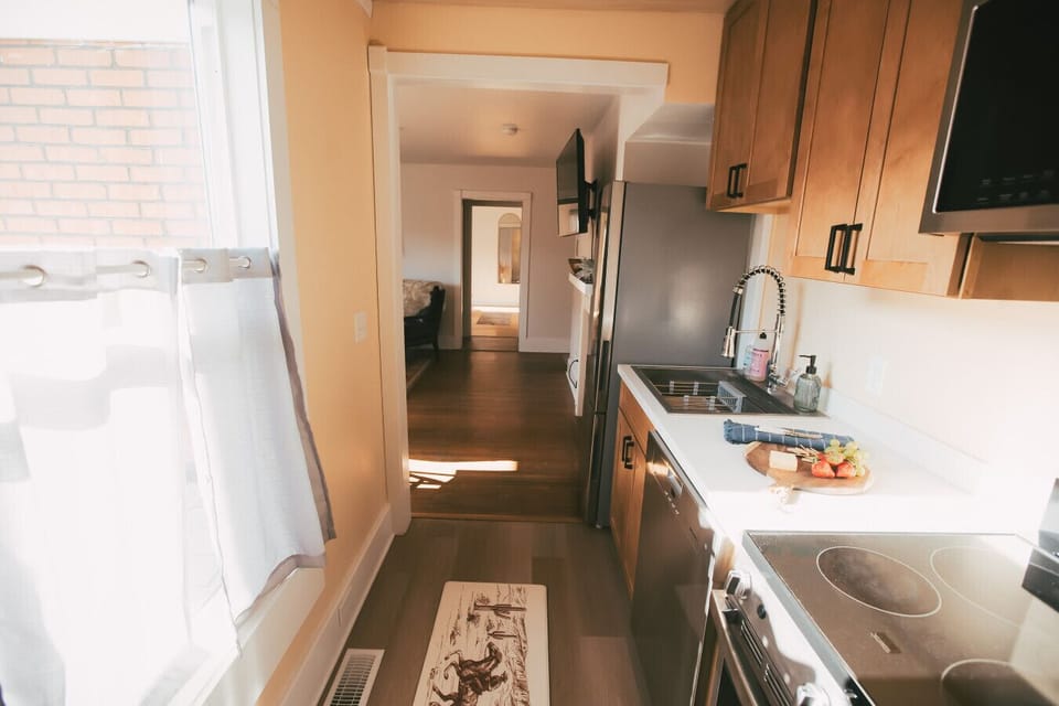 Flathead Apartment #4- A compact kitchen that earns its keep — everything within reach and well-stocked to boot.