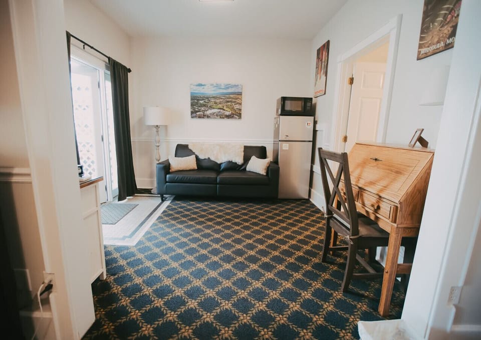 Clark Fork Suite #1- A cozy living space complete with writing desk, mini fridge and microwave, and a beautiful view out onto a private porch overlooking the Clark Fork River