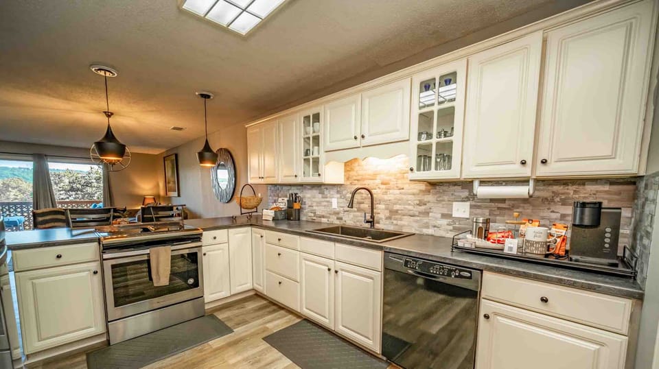 Fully equipped kitchen with white cabinetry, stainless appliances, and generous counter space for easy vacation meals
