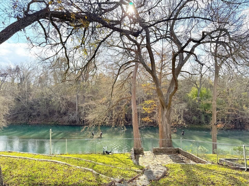 Anglers wade in the river as they cast a line