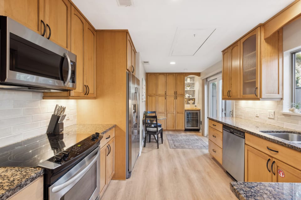 Fully stocked kitchen with stainless steel appliances .