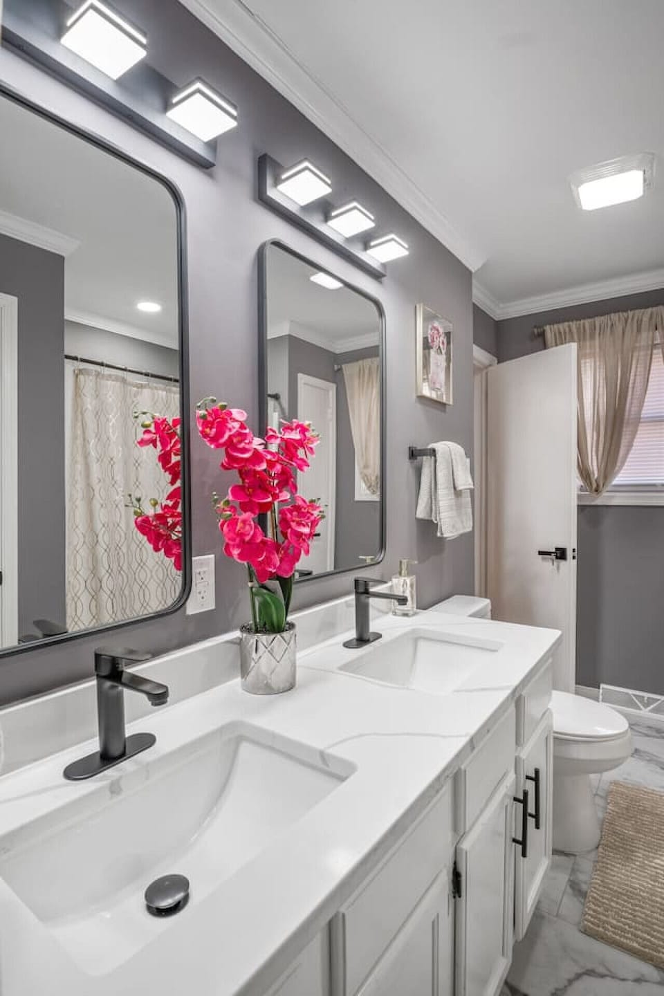 Pamper yourself with double sinks, a shower/tub combo, and elegant decor. Convenient hallway access is available and this bathroom is attached to the master bedroom.