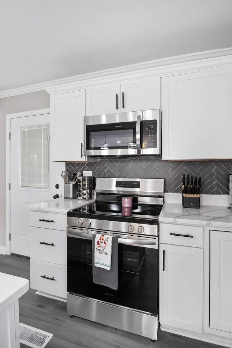 Whip up culinary delights in a fully equipped kitchen- a snack basket too! Enjoy a spacious island and seating for two, a coffee corner, and all the essentials! Direct access to the deck and downstairs area makes this kitchen the heart of the home.