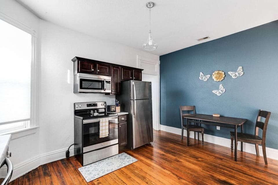 Fully equipped with everything you need, including a dishwasher, sink, oven range, microwave, toaster, and Keurig. A long dining table with seating for two along with ample cabinet space for storage is a plus.