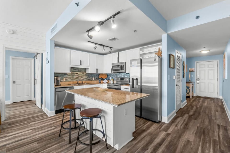 fully equipped kitchen with ample counter space, sleek appliances, and a breakfast bar for a perfect start to your day