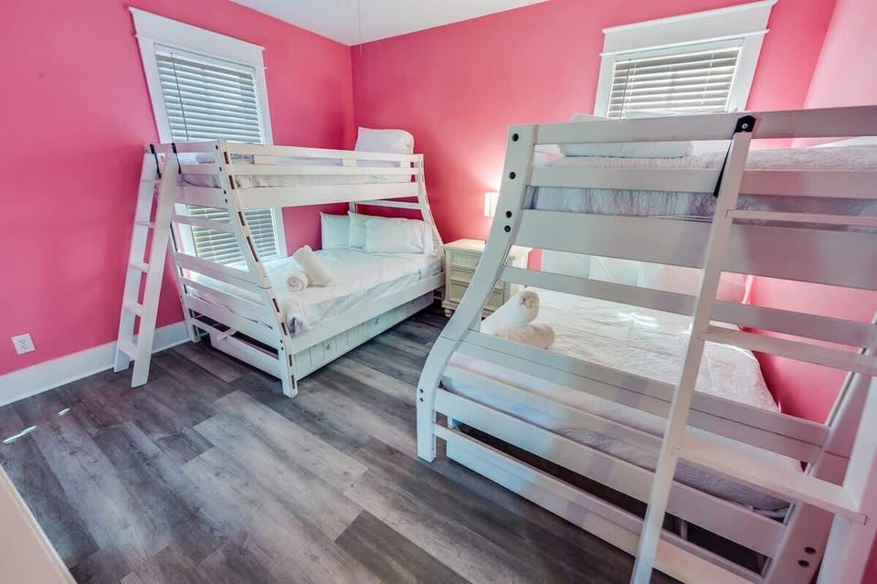 - Cheerful bunk room featuring pink walls, perfect for families, kids, or groups - Comfortable and spacious beds provide a fun and relaxing sleep setup - Lively space designed for making memories, laughter, and cozy nights