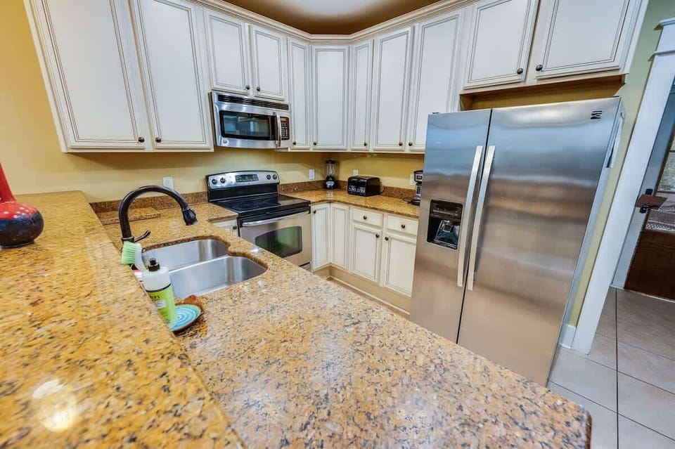 - Well equipped kitchen featuring stainless steel appliances and plenty of counter space - Classic cabinetry and modern finishes make meal preparation a breeze - Welcoming space to cook, gather, and enjoy delicious homemade meals