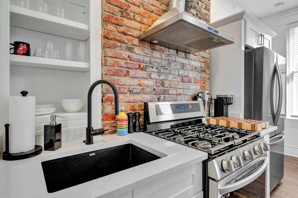 Kitchen: Elegant sink setup complemented by a convenient paper towel holder, combining functionality with a clean, organized look.