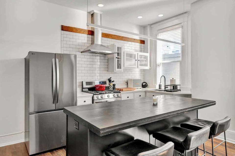 First unit - Modern fully equipped kitchen featuring stainless steel appliances, sleek countertops, ample cabinetry, and all the essentials for effortless cooking and entertaining.