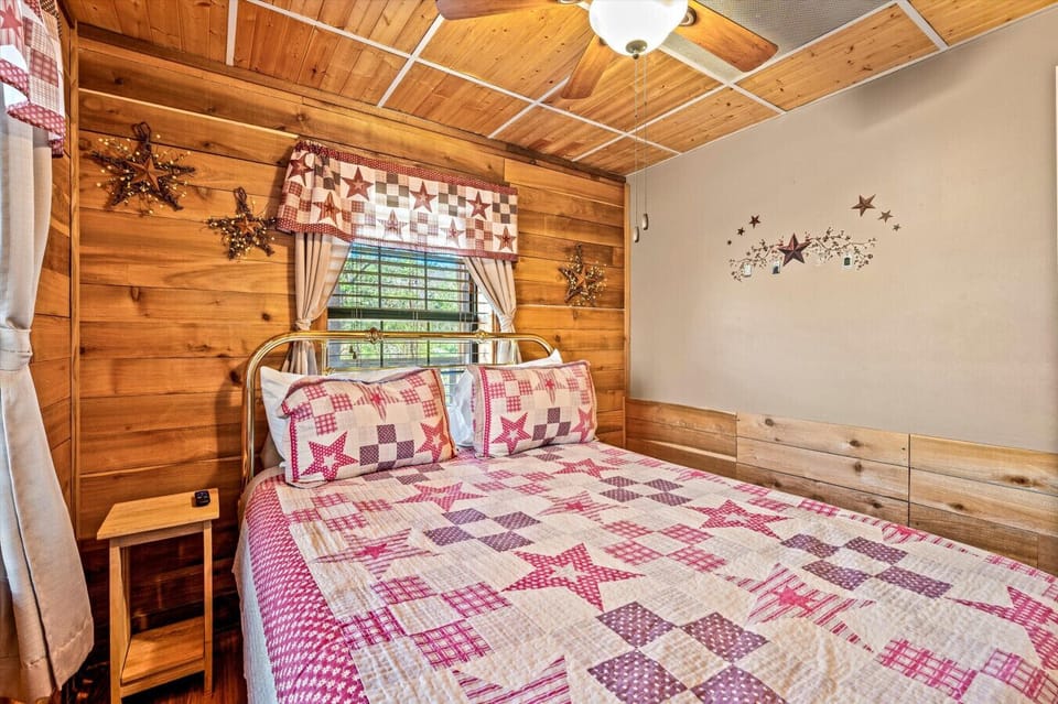 A closer look at the inviting textures and details that make this bedroom feel like a true retreat—layered quilts, natural wood, and a calm, homey vibe.