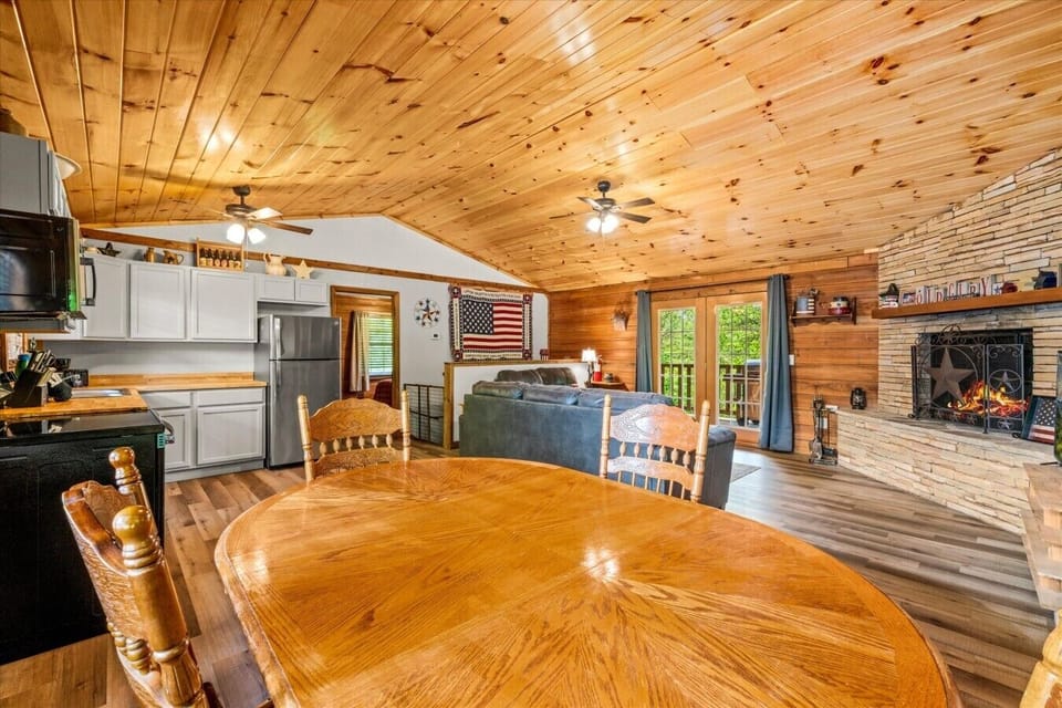 Gather around the dining table surrounded by natural light and cabin charm. This cozy nook is ideal for family dinners, board games, or a leisurely breakfast before heading out.