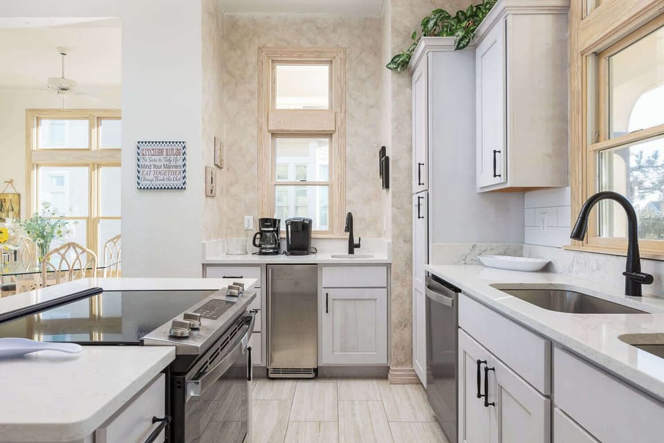 Mid Level: Newly remodeled kitchen with breakfast bar seating for 3, a stove, refrigerator, dishwasher, microwave, oven, toaster, drip coffee machine, blender and more