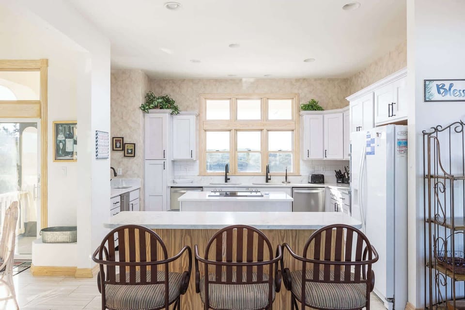 Mid Level: Newly remodeled kitchen with breakfast bar seating for 3, a stove, refrigerator, dishwasher, microwave, oven, toaster, drip coffee machine, blender and more