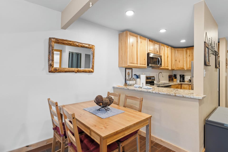 Your fully equipped kitchen and dining area features warm wood cabinets, granite countertops, and everything you need for memorable meals together.