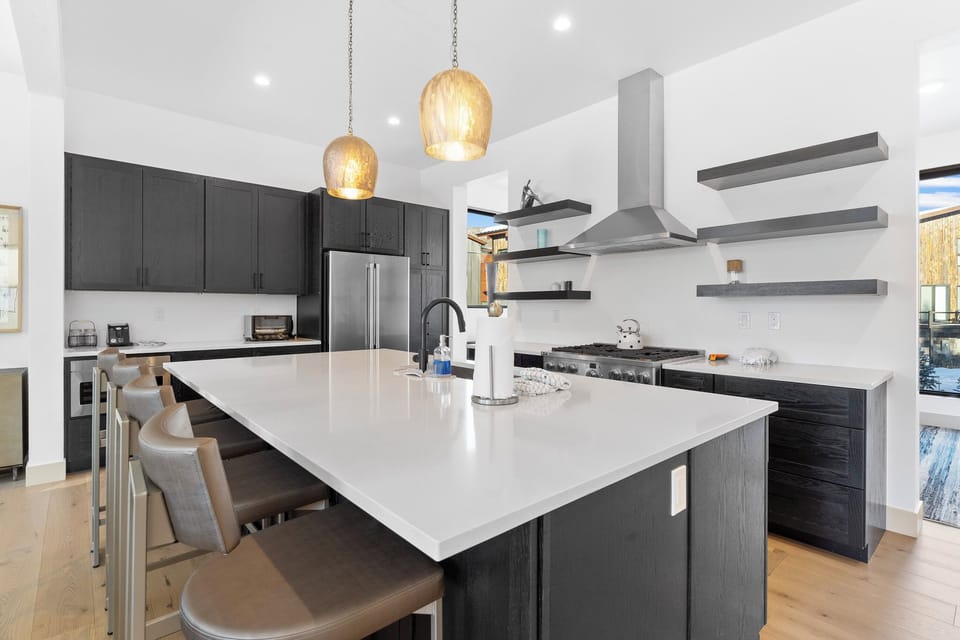 Full kitchen featuring stainless steel appliances, large island, and breakfast bar seating 4 for casual dining.