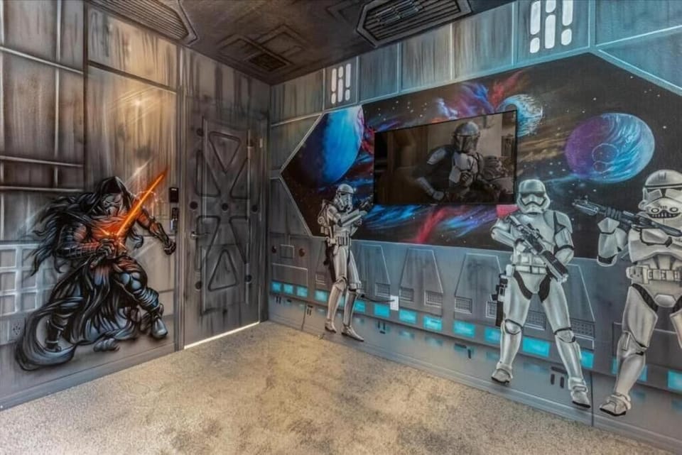 Galactic-themed media room with space murals, star warriors, and immersive sci-fi vibes.
