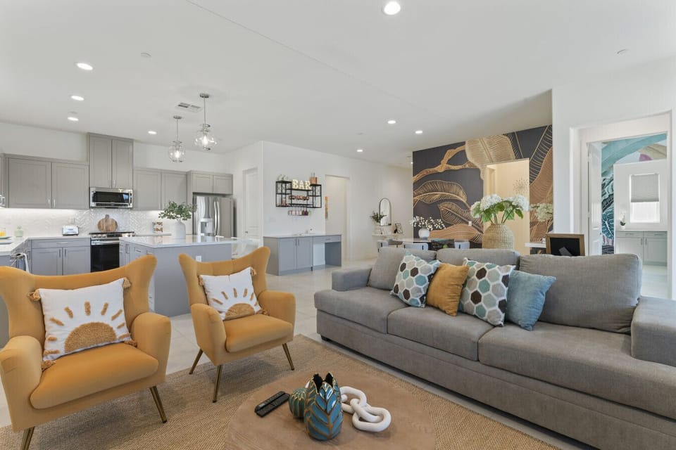 Open living space w/ cozy sofa, accent chairs & easy flow into the kitchen