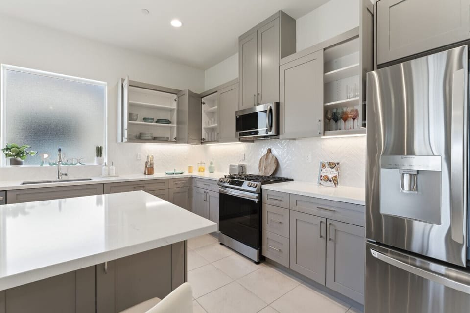 Modern kitchen w/ sleek cabinetry, stainless appliances & ample counter space
