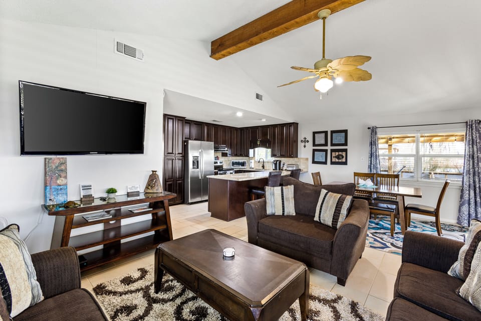 Open living room with ample seating and a TV.