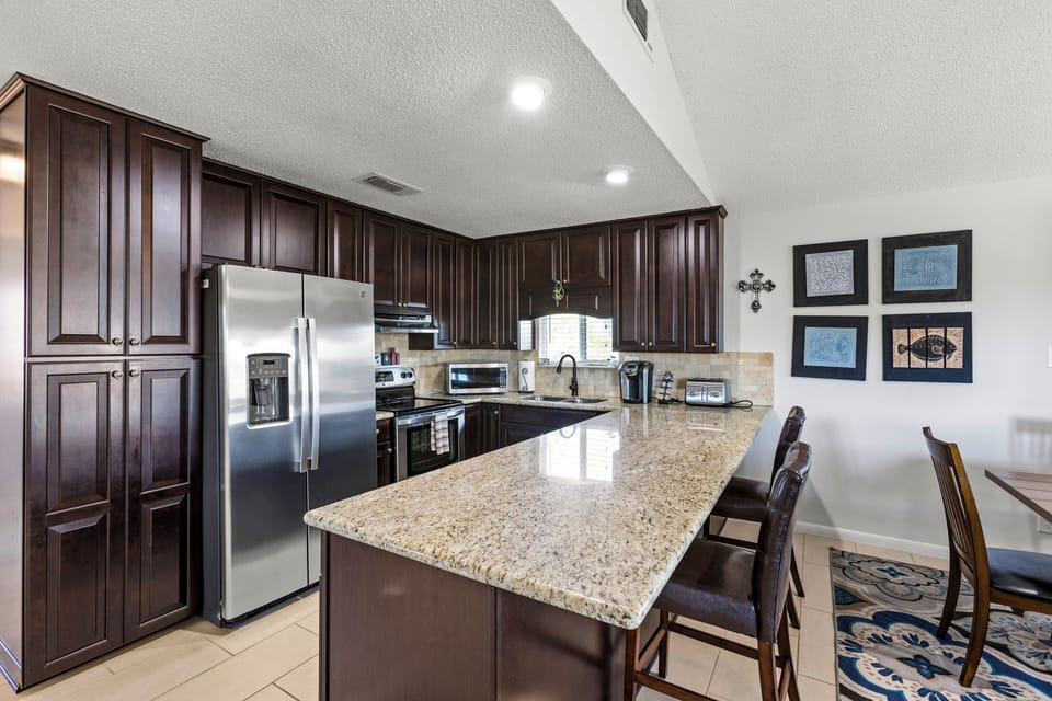 This kitchen has all the amenities and a large island. 