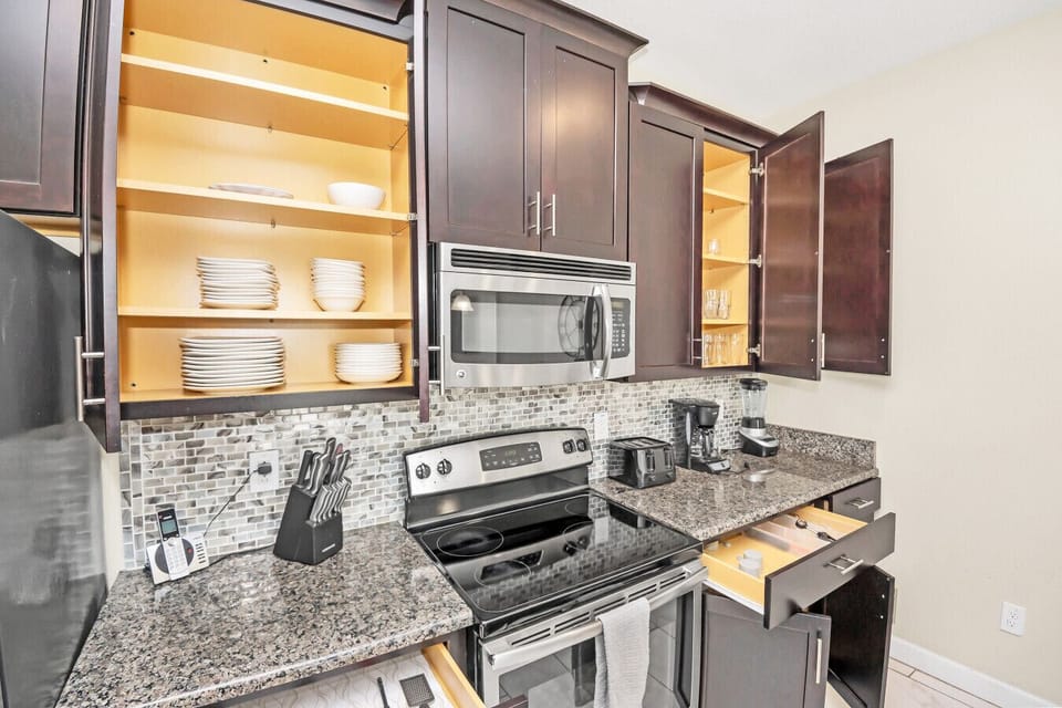 Modern kitchen with stocked cabinets and granite countertops.