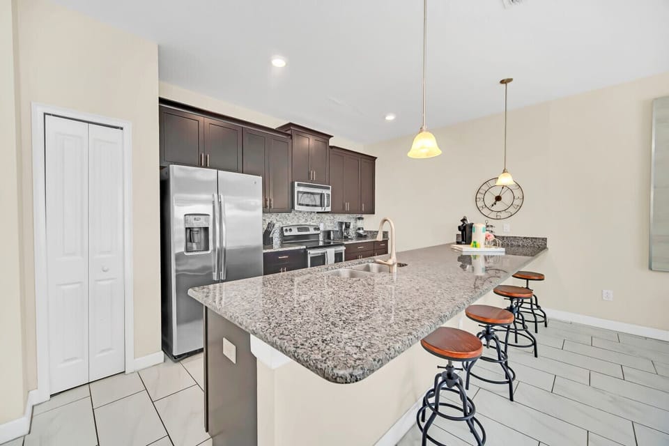 Spacious kitchen with granite countertops and modern appliances.