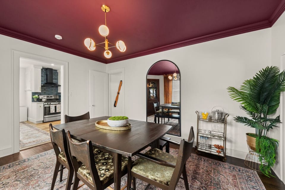 Vintage charm meets modern style in this gorgeous dining room.  The burgundy ceiling is a showstopper!