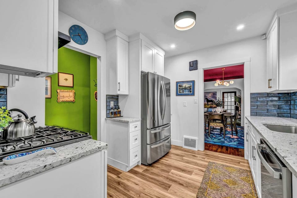 Kitchen w/ colorful accents & open layout.