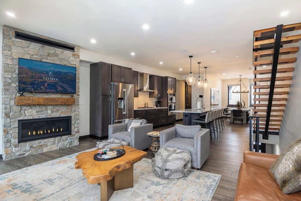 - Cook, dine, and unwind in a seamless space that blends rustic warmth with modern flow
- Stone fireplace and wood accents pair perfectly with the sleek kitchen design
- Gather around the island or relax fireside with your crew