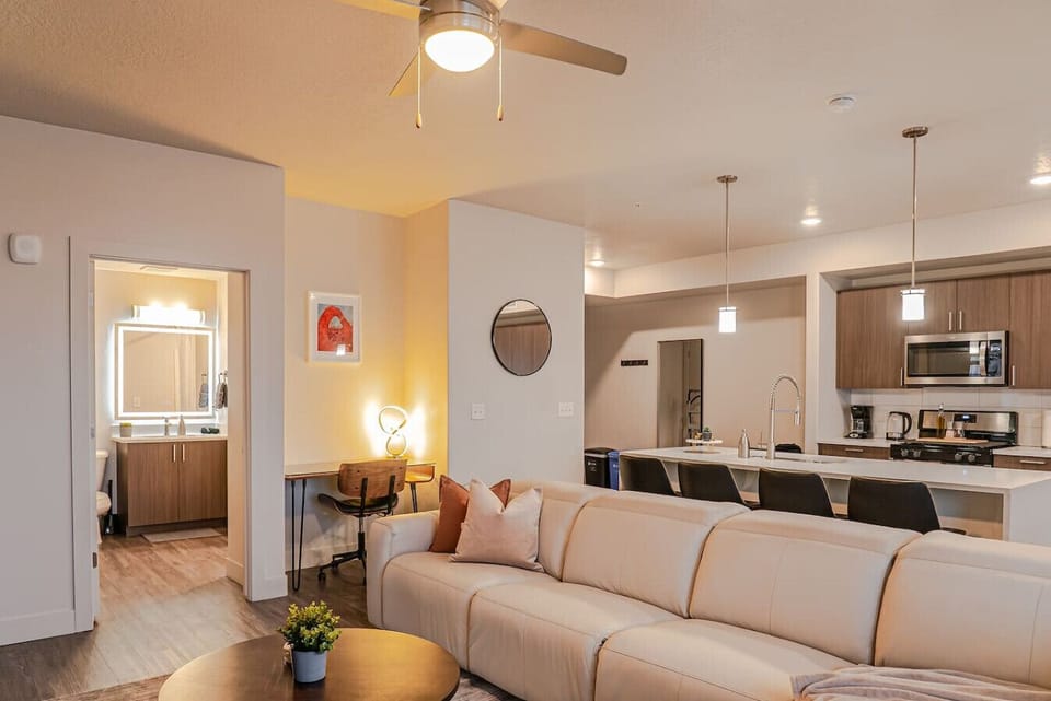 Beautifully designed living room. 75` TV, leather sofa and amazing views of mountains and city skyline.