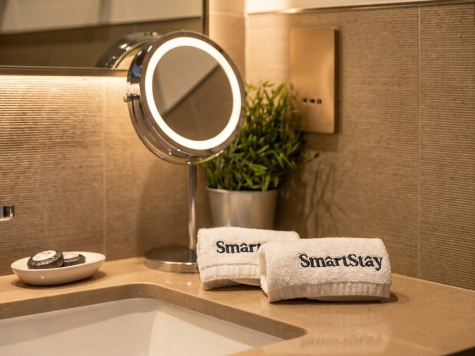 Bathroom Vanity with SmartStay Towels Round Mirror and Plant