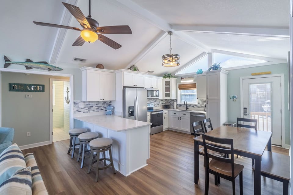 Dining Area - Grab a bit or play a game at the large dining table in the open concept living and kitchen area.
