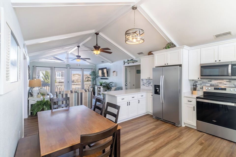 Dining Area - Grab a bit or play a game at the large dining table in the open concept living and kitchen area.