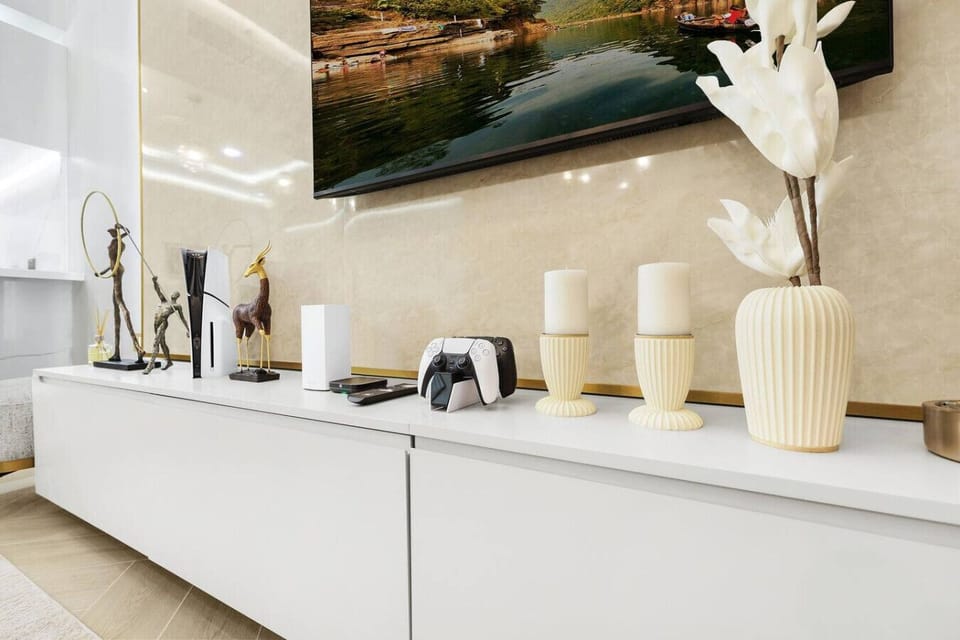 Entertainment Hub: Stylish decor meets gaming bliss with a PlayStation and stunning TV backdrop!