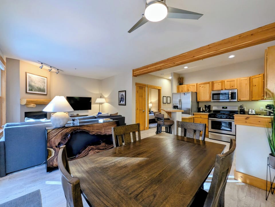 Gather around your spacious dining table for memorable meals, with a fully equipped kitchen and cozy living area creating the perfect home base.