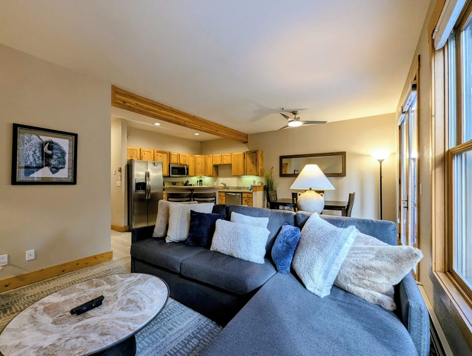 Sink into this plush sectional sofa where you can unwind after your mountain adventures, with your fully equipped kitchen just steps away.