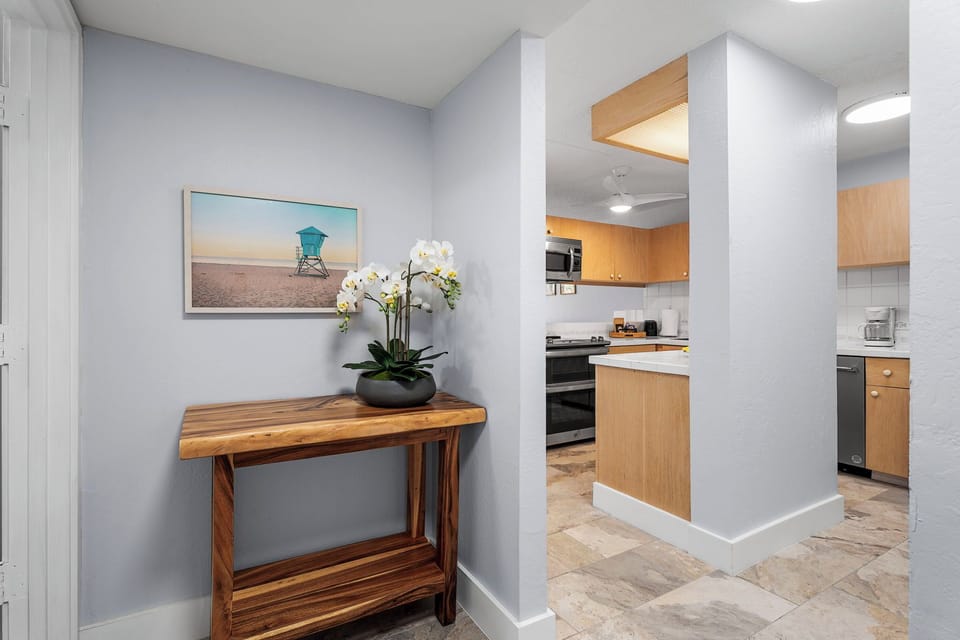 Entryway console with tasteful artwork and decorative accents.